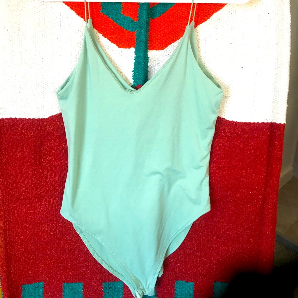 Light blue soft body suit.